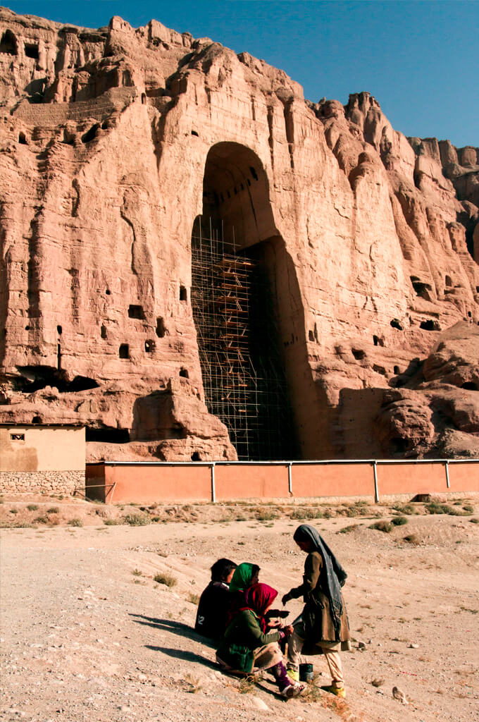 Working children playing near Buddha of Bamyan