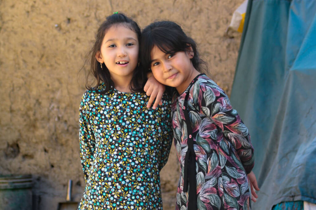 Two little girls pose for the camera in Gazni province